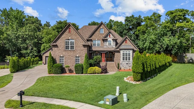 429 Acacia Grove Ln, Lebanon, TN 37087 - craftsman-style house with driveway, a garage, brick siding, and stone siding