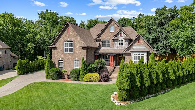 429 Acacia Grove Ln, Lebanon, TN 37087 - view of front of home with a front yard, brick siding, driveway, and roof with shingles