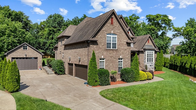 429 Acacia Grove Ln, Lebanon, TN 37087 - view of front of house featuring brick siding, a front yard, an outdoor structure, roof with shingles, and driveway