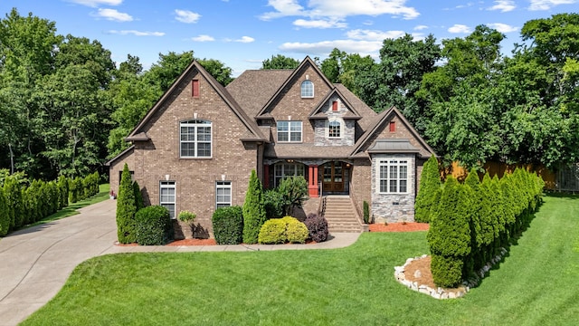 429 Acacia Grove Ln, Lebanon, TN 37087 - craftsman-style home featuring stairs, a front yard, driveway, brick siding, and a porch