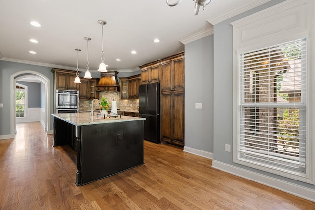 429 Acacia Grove Ln, Lebanon, TN 37087 - kitchen featuring freestanding refrigerator, tasteful backsplash, double oven, arched walkways, and crown molding