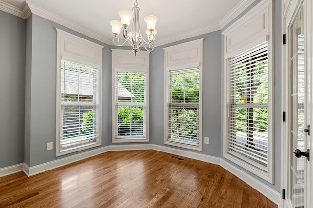 429 Acacia Grove Ln, Lebanon, TN 37087 - unfurnished dining area with wood finished floors, a chandelier, healthy amount of natural light, and ornamental molding
