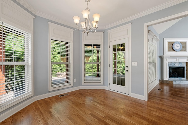 429 Acacia Grove Ln, Lebanon, TN 37087 - unfurnished dining area featuring a chandelier, wood finished floors, crown molding, and a fireplace