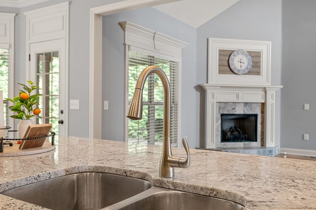429 Acacia Grove Ln, Lebanon, TN 37087 - kitchen with light stone countertops, lofted ceiling, and a premium fireplace
