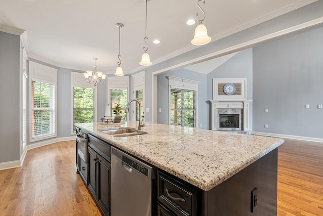 429 Acacia Grove Ln, Lebanon, TN 37087 - kitchen featuring stainless steel dishwasher, light wood-style floors, a chandelier, open floor plan, and light stone countertops