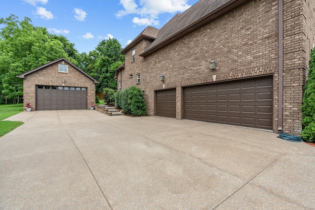 429 Acacia Grove Ln, Lebanon, TN 37087 - view of side of property featuring a garage, brick siding, and an outbuilding