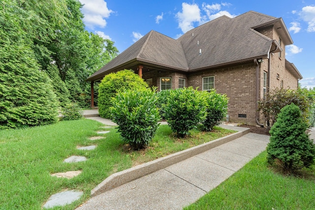 429 Acacia Grove Ln, Lebanon, TN 37087 - view of home's exterior featuring brick siding, roof with shingles, and a yard