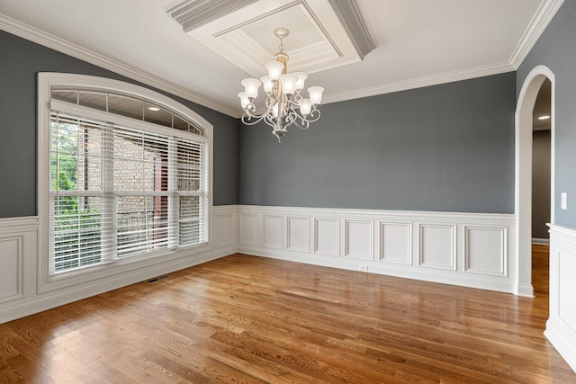 429 Acacia Grove Ln, Lebanon, TN 37087 - empty room with crown molding, a wainscoted wall, a chandelier, arched walkways, and light wood-type flooring