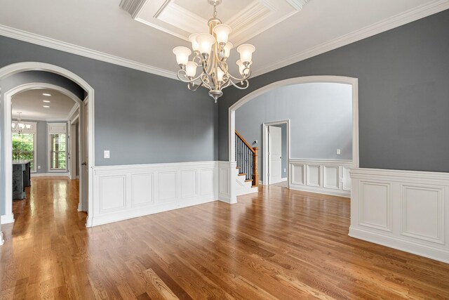 429 Acacia Grove Ln, Lebanon, TN 37087 - spare room featuring a chandelier, arched walkways, crown molding, wood finished floors, and stairway