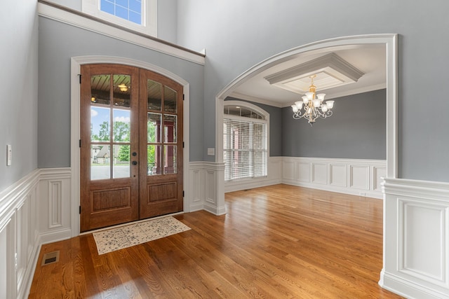 429 Acacia Grove Ln, Lebanon, TN 37087 - foyer with a chandelier, arched walkways, wainscoting, light wood finished floors, and ornamental molding