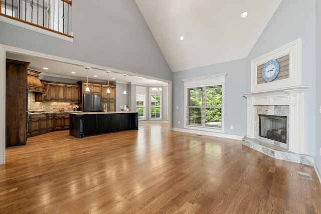 429 Acacia Grove Ln, Lebanon, TN 37087 - unfurnished living room featuring high vaulted ceiling, a high end fireplace, light wood finished floors, and recessed lighting