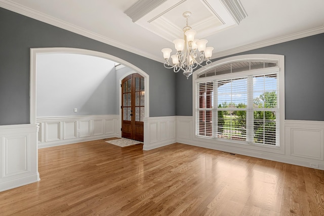429 Acacia Grove Ln, Lebanon, TN 37087 - unfurnished room with a chandelier, arched walkways, wainscoting, ornamental molding, and light wood-style floors