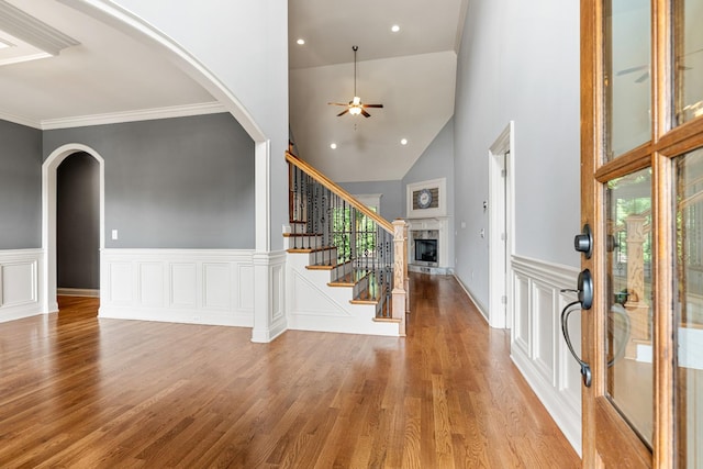 429 Acacia Grove Ln, Lebanon, TN 37087 - entryway featuring ceiling fan, a fireplace with raised hearth, wood finished floors, arched walkways, and stairs