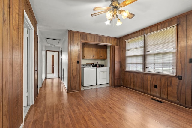 2706 Walnut Ln, Murfreesboro, TN 37129 - kitchen featuring independent washer and dryer, ceiling fan, wood walls, light wood-style flooring, and brown cabinetry