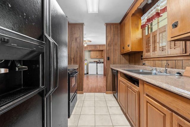 2706 Walnut Ln, Murfreesboro, TN 37129 - kitchen with washer and dryer, black appliances, light countertops, light tile patterned floors, and a ceiling fan