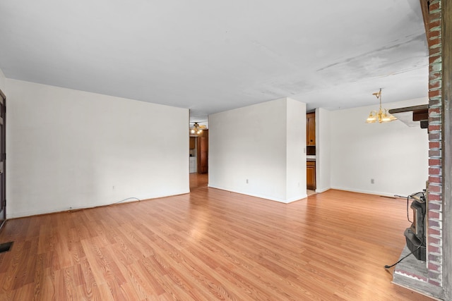 2706 Walnut Ln, Murfreesboro, TN 37129 - unfurnished living room featuring a chandelier and light wood-style flooring