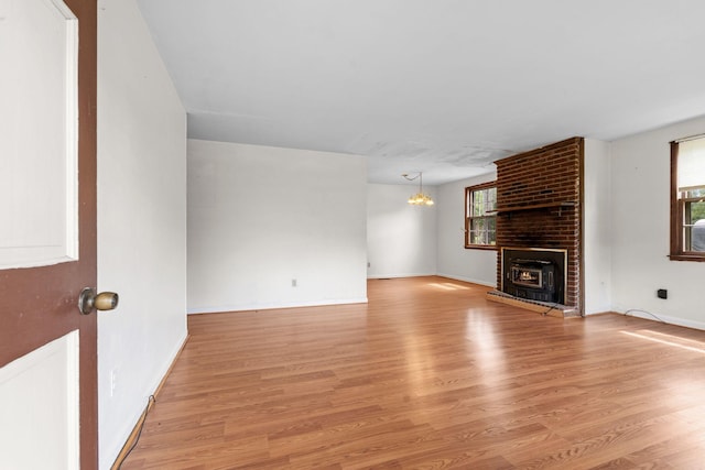 2706 Walnut Ln, Murfreesboro, TN 37129 - unfurnished living room featuring light wood-style flooring, healthy amount of natural light, and a chandelier
