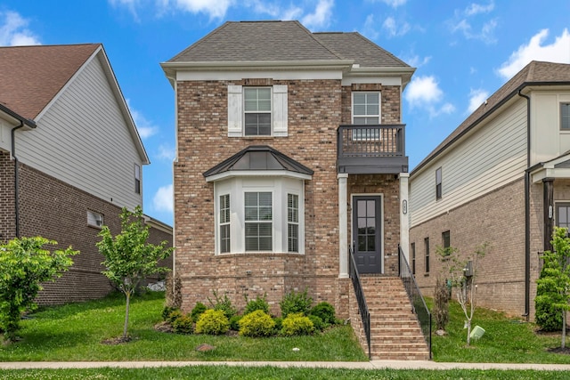 240 Sounder Cir, La Vergne, TN 37086 - traditional-style home featuring a balcony, brick siding, a front yard, and roof with shingles