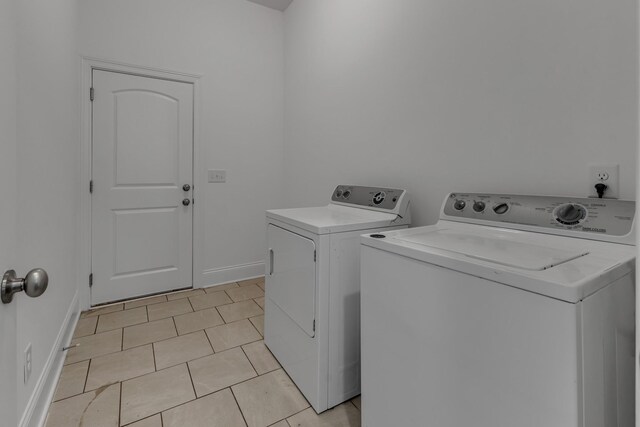 240 Sounder Cir, La Vergne, TN 37086 - washroom featuring washing machine and clothes dryer and light tile patterned floors