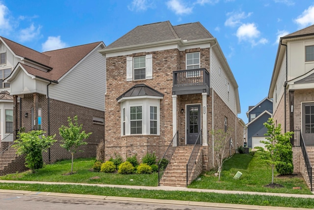 240 Sounder Cir, La Vergne, TN 37086 - view of front of house with brick siding, a balcony, stairway, and a front lawn