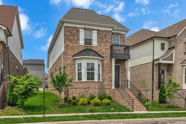 240 Sounder Cir, La Vergne, TN 37086 - view of front of home featuring a balcony, brick siding, and a front lawn