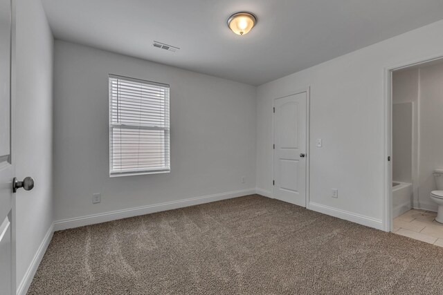 240 Sounder Cir, La Vergne, TN 37086 - unfurnished bedroom with light carpet, connected bathroom, and light tile patterned floors
