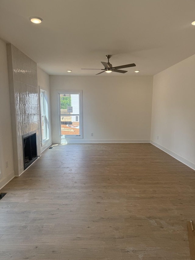 321 Wesson Dr, Clarksville, TN 37043 - unfurnished living room with a ceiling fan, recessed lighting, wood finished floors, and a large fireplace
