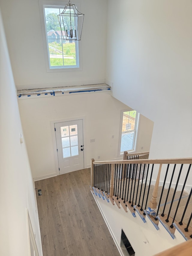 321 Wesson Dr, Clarksville, TN 37043 - stairway with wood finished floors, plenty of natural light, a high ceiling, and a chandelier