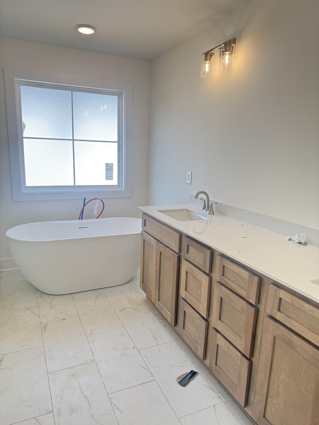 321 Wesson Dr, Clarksville, TN 37043 - bathroom with marble look tiles, a freestanding tub, double vanity, and recessed lighting