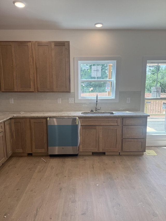 321 Wesson Dr, Clarksville, TN 37043 - kitchen featuring dishwasher, light wood-style floors, backsplash, brown cabinetry, and recessed lighting