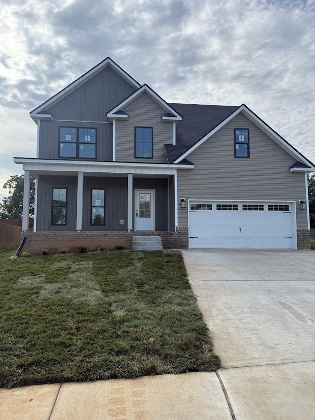 321 Wesson Dr, Clarksville, TN 37043 - view of front of house with concrete driveway, a front yard, brick siding, and a porch