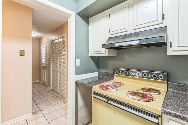 5430 Gatehouse Dr Unit 5430, Memphis, TN 38134 - kitchen with white electric stove, under cabinet range hood, light tile patterned floors, white cabinets, and dark countertops