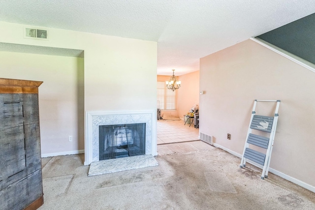 5430 Gatehouse Dr Unit 5430, Memphis, TN 38134 - unfurnished living room with carpet floors, a chandelier, a textured ceiling, and a high end fireplace