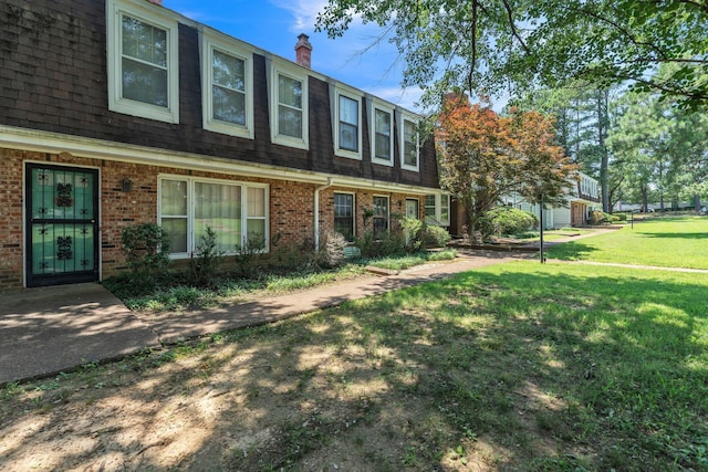 5430 Gatehouse Dr Unit 5430, Memphis, TN 38134 - view of front of property featuring brick siding, a front yard, a chimney, and a shingled roof