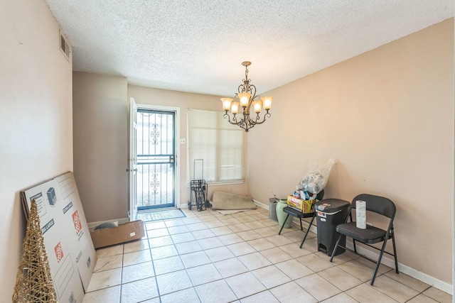 5430 Gatehouse Dr Unit 5430, Memphis, TN 38134 - unfurnished room featuring a chandelier, light tile patterned floors, and a textured ceiling