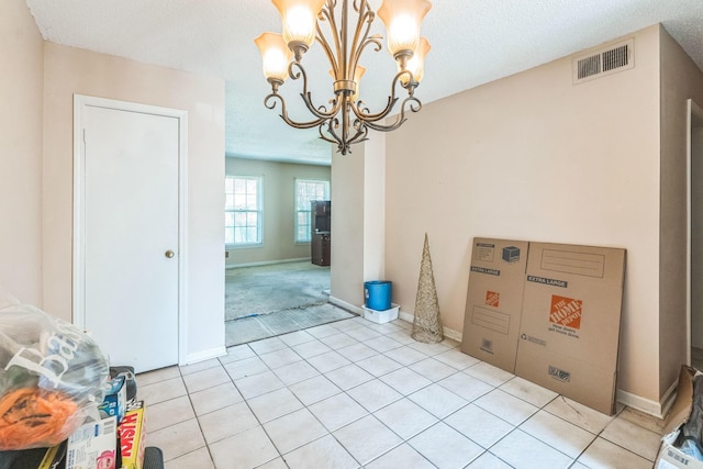 5430 Gatehouse Dr Unit 5430, Memphis, TN 38134 - unfurnished dining area with a chandelier, light tile patterned flooring, and a textured ceiling