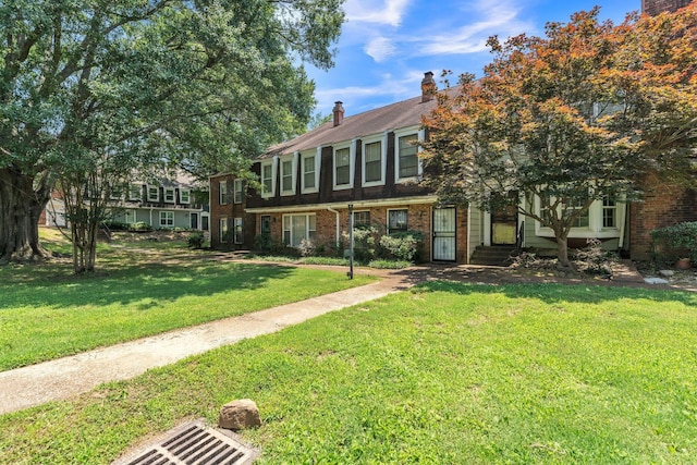 5430 Gatehouse Dr Unit 5430, Memphis, TN 38134 - view of property featuring brick siding, a front yard, and a chimney