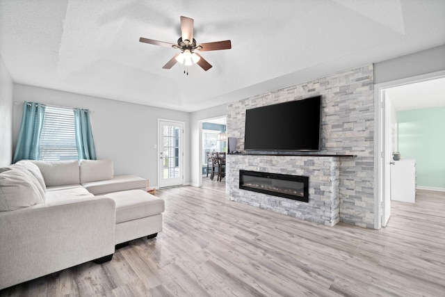 919 Desota Ln, Oak Grove, KY 42262 - living room with wood finished floors, a raised ceiling, ceiling fan, and a stone fireplace