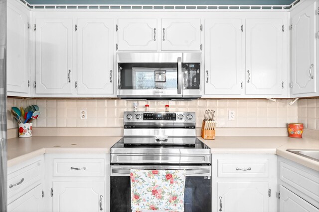 919 Desota Ln, Oak Grove, KY 42262 - kitchen with appliances with stainless steel finishes, light countertops, white cabinets, and backsplash