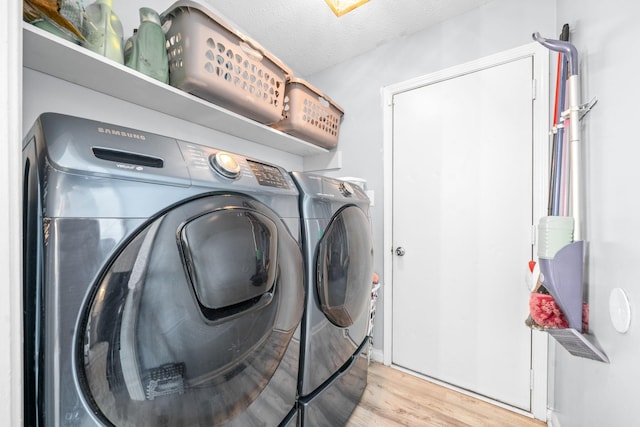 919 Desota Ln, Oak Grove, KY 42262 - laundry area featuring separate washer and dryer, wood finished floors, and a textured ceiling