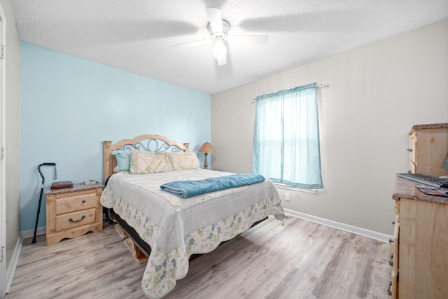 919 Desota Ln, Oak Grove, KY 42262 - bedroom with light wood-style floors, a textured ceiling, and a ceiling fan