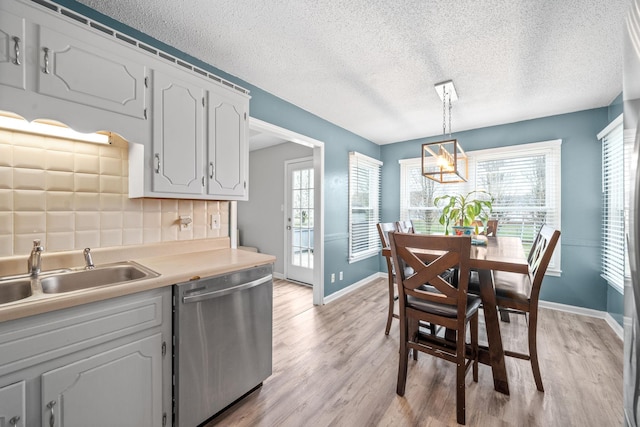 919 Desota Ln, Oak Grove, KY 42262 - kitchen with dishwasher, light wood-style floors, plenty of natural light, a textured ceiling, and light countertops