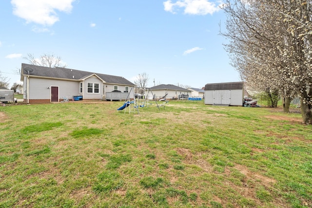 919 Desota Ln, Oak Grove, KY 42262 - view of grassy yard featuring a storage shed and a playground