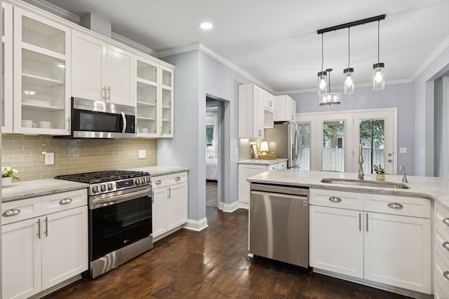 721 Shadowlawn Ct, Franklin, TN 37069 - kitchen featuring appliances with stainless steel finishes, white cabinetry, crown molding, backsplash, and decorative light fixtures