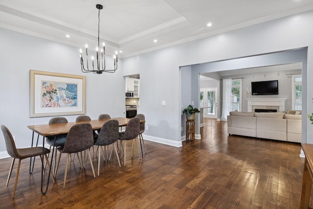 721 Shadowlawn Ct, Franklin, TN 37069 - dining area with dark wood-type flooring, a chandelier, recessed lighting, ornamental molding, and a fireplace