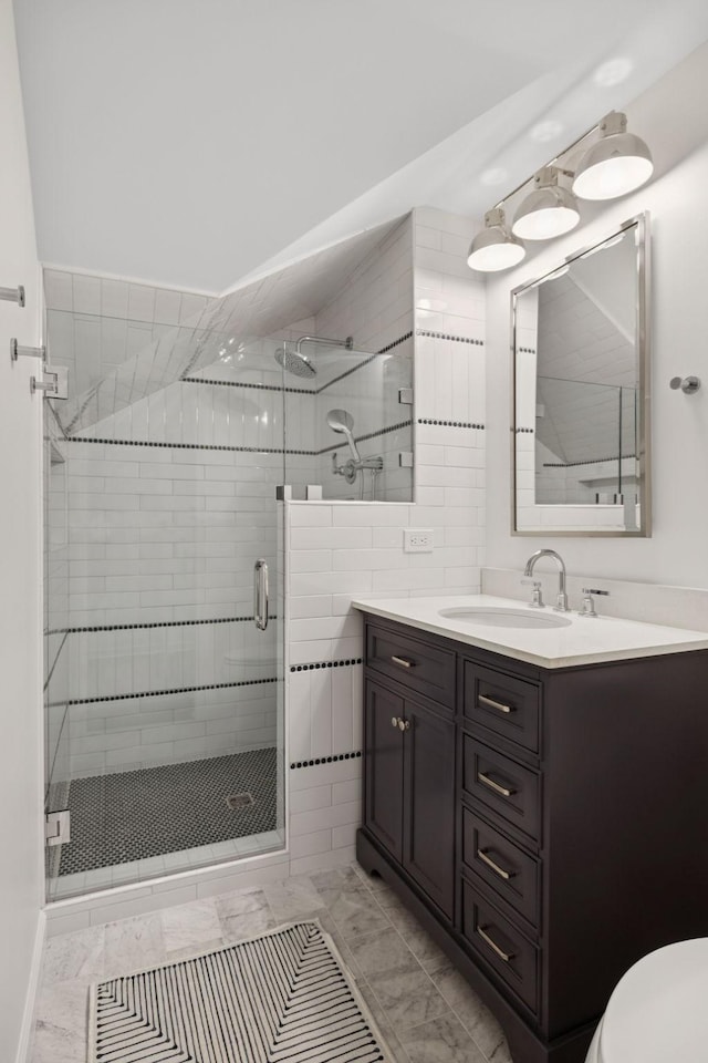 721 Shadowlawn Ct, Franklin, TN 37069 - bathroom featuring a shower stall, vanity, and marble look tile flooring