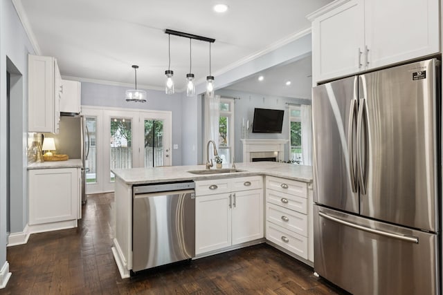721 Shadowlawn Ct, Franklin, TN 37069 - kitchen with stainless steel appliances, a peninsula, white cabinets, dark wood-style flooring, and ornamental molding
