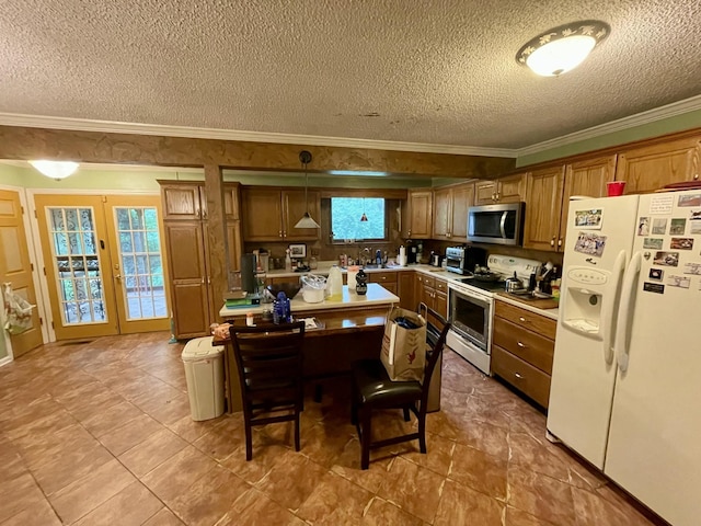 412 Howard Cir, Chattanooga, TN 37411 - kitchen featuring white appliances, a textured ceiling, light countertops, a center island, and brown cabinetry