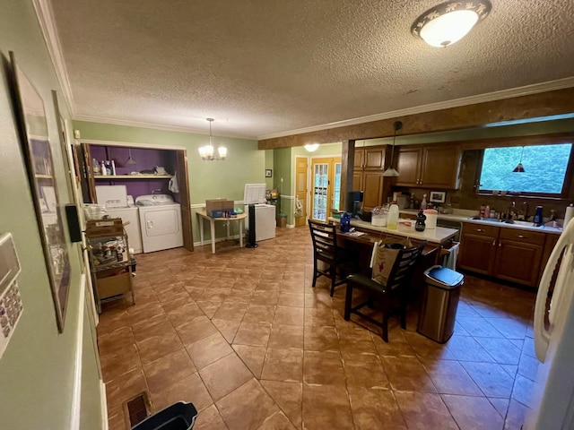 412 Howard Cir, Chattanooga, TN 37411 - kitchen with crown molding, a textured ceiling, a chandelier, separate washer and dryer, and light countertops
