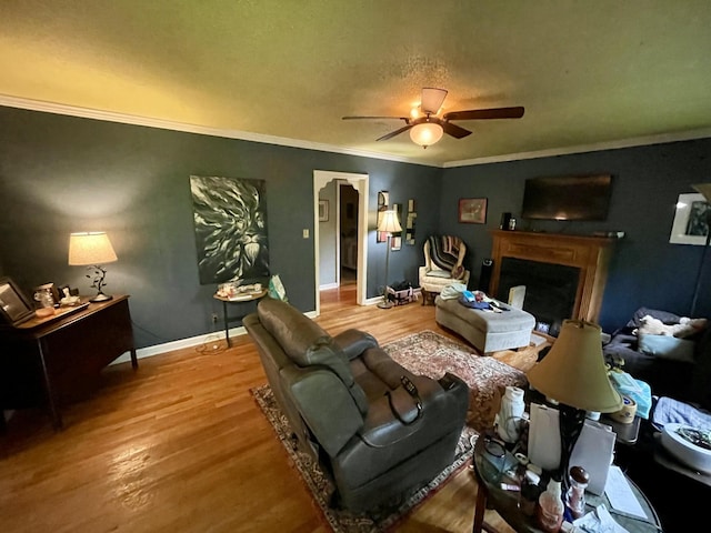 412 Howard Cir, Chattanooga, TN 37411 - living room featuring a ceiling fan, wood finished floors, a fireplace, and crown molding